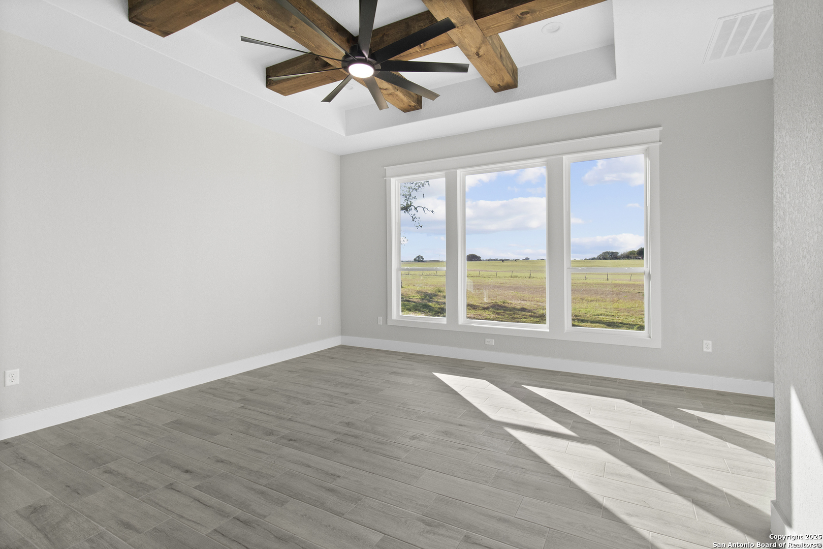 116 Western Way Adkins, TX 78101 - Photo 34 of 50 a view of an empty room with wooden floor and a window