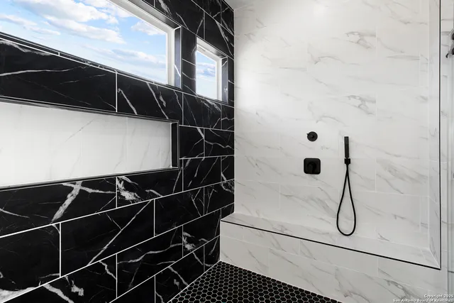 a bathroom with a shower and a glass door