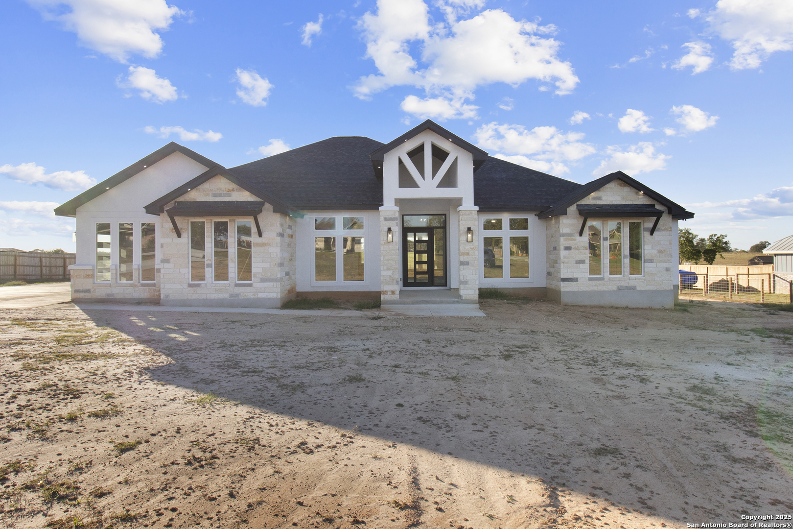 116 Western Way Adkins, TX 78101 - Photo 7 of 50 a front view of a house with a garden and trees