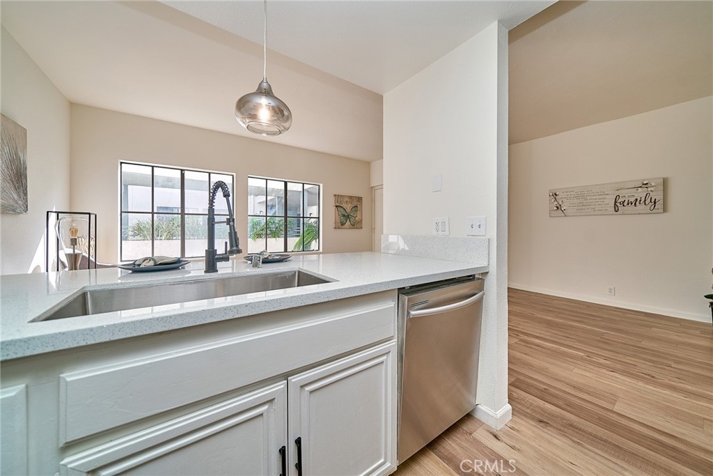 720 West 4th Street, Unit 305 Long Beach, CA 90802 - Photo 12 of 52 a kitchen with a sink and wooden floor