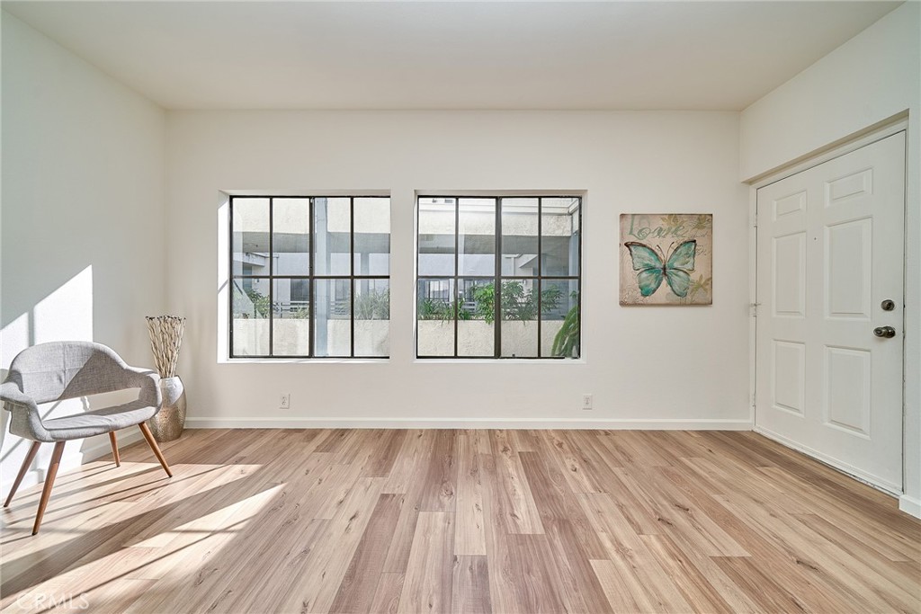 720 West 4th Street, Unit 305 Long Beach, CA 90802 - Photo 13 of 52 a view of a room with wooden floor and a window