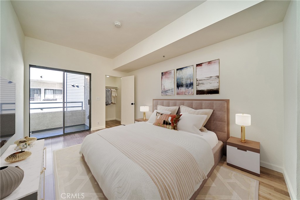 720 West 4th Street, Unit 305 Long Beach, CA 90802 - Photo 20 of 52 a bedroom with a bed and a view of kitchen
