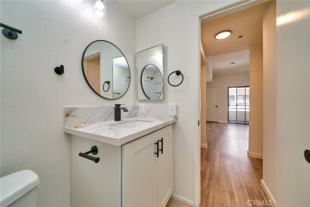 720 West 4th Street, Unit 305 Long Beach, CA 90802 - Photo 24 of 52 a bathroom with a sink and a mirror