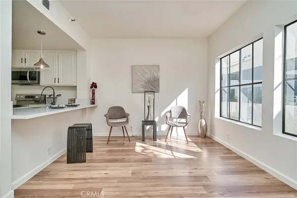 a living room with furniture wooden floor and a window