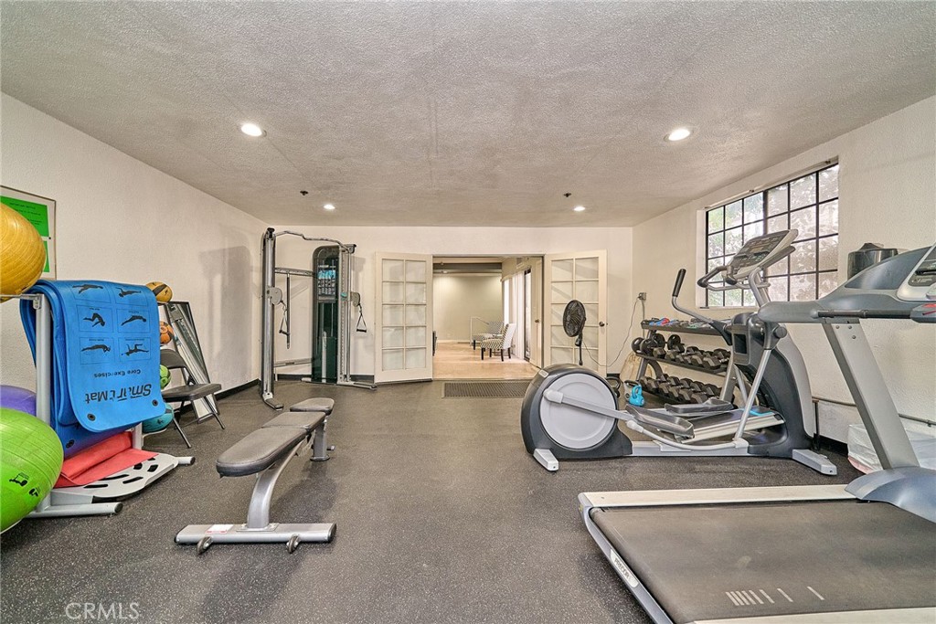 720 West 4th Street, Unit 305 Long Beach, CA 90802 - Photo 33 of 52 a room with gym equipment and a mirror