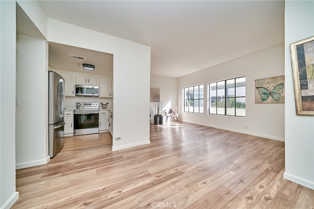 720 West 4th Street, Unit 305 Long Beach, CA 90802 - Photo 4 of 52 wooden floor fireplace and windows in an empty room