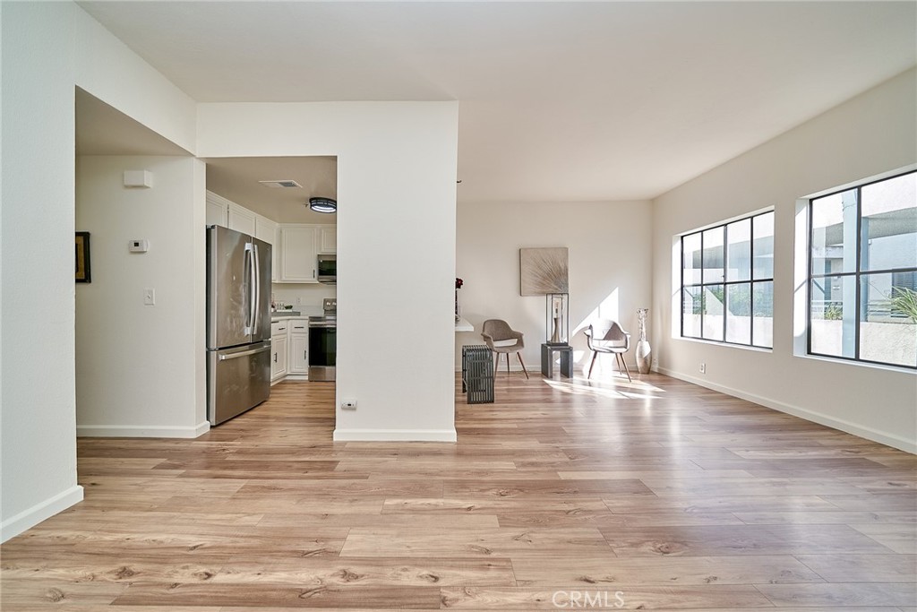 720 West 4th Street, Unit 305 Long Beach, CA 90802 - Photo 8 of 52 an empty room with wooden floor and windows
