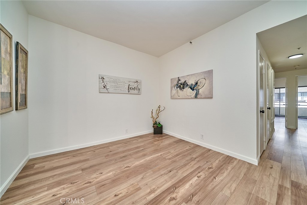 720 West 4th Street, Unit 305 Long Beach, CA 90802 - Photo 9 of 52 a view of a room with wooden floor and a large window