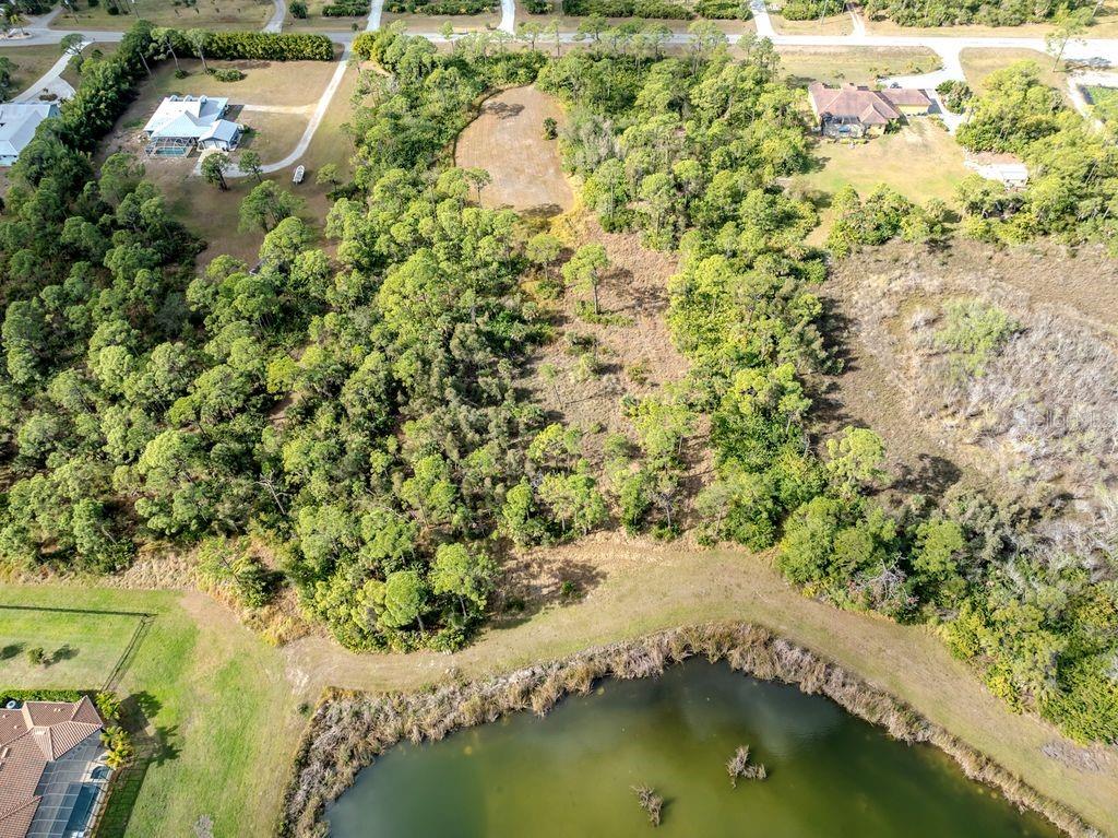 9008 Falcon Court Venice, FL 34293 - Photo 5 of 26 an aerial view of residential house with outdoor space and trees all around