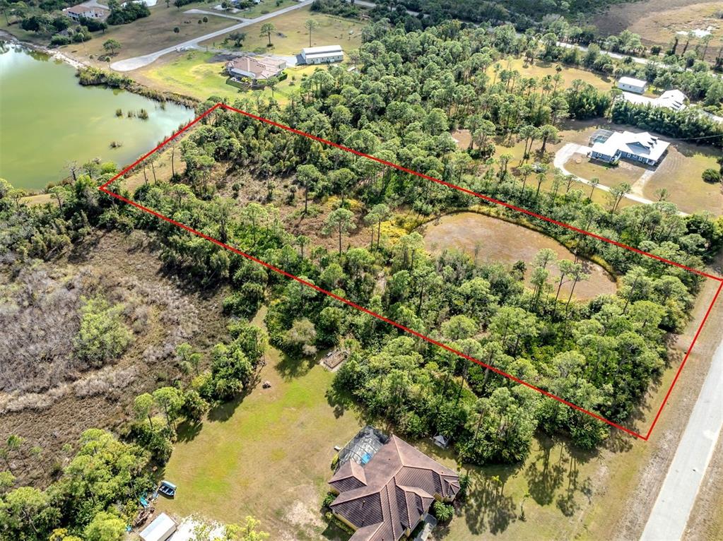 9008 Falcon Court Venice, FL 34293 - Photo 7 of 26 an aerial view of residential houses with outdoor space and trees all around