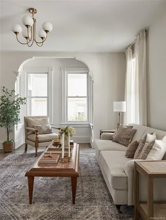 a living room with furniture and a potted plant