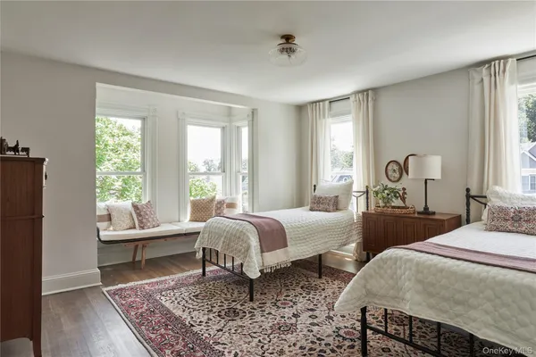 a bedroom with two beds and a large window