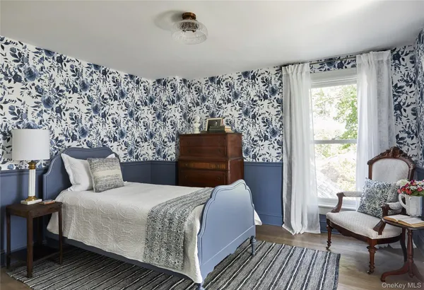 a bedroom with bed and wooden floor