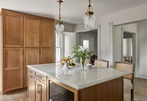 a kitchen with a sink a refrigerator and a table