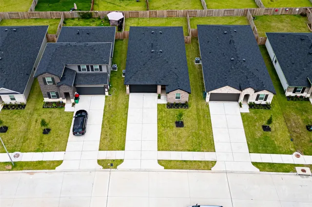 an aerial view of houses with yard