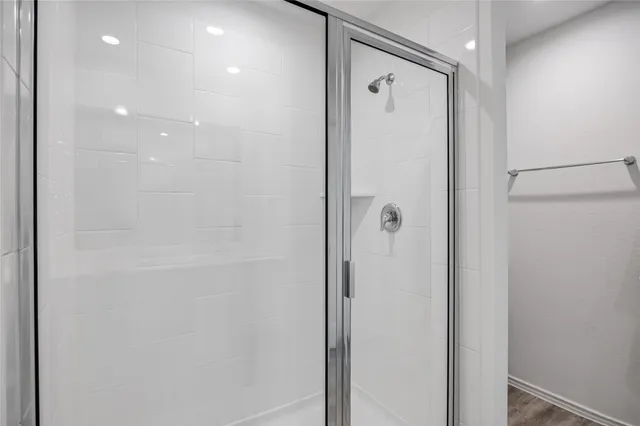 a bathroom with a glass shower door
