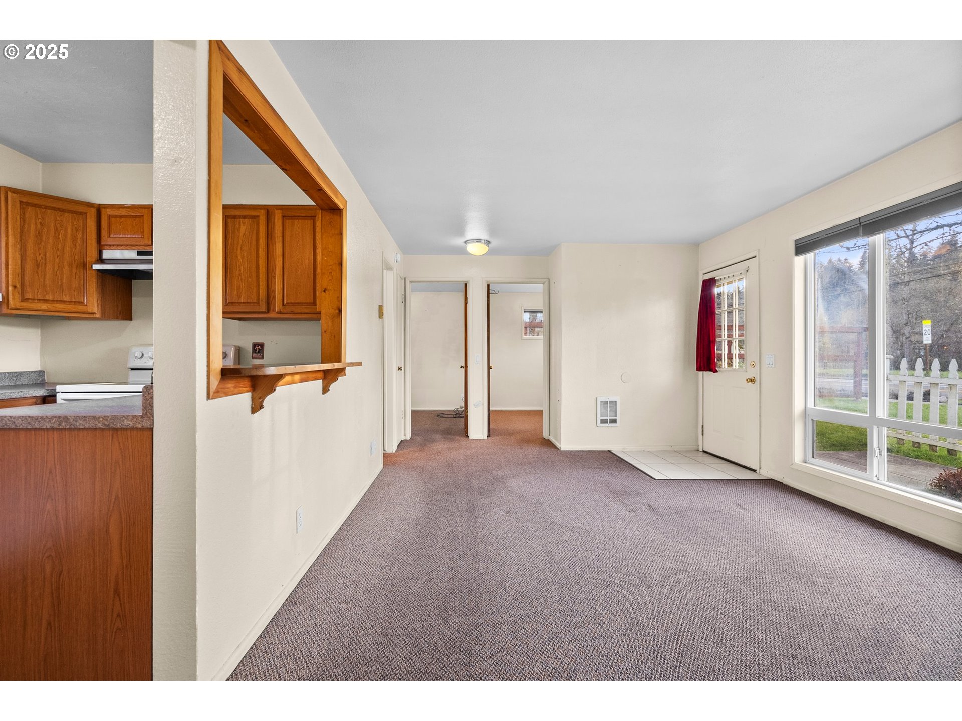 3875 East Amazon Drive Eugene, OR 97405 - Photo 12 of 33 a view of a kitchen with wooden floor and a refrigerator