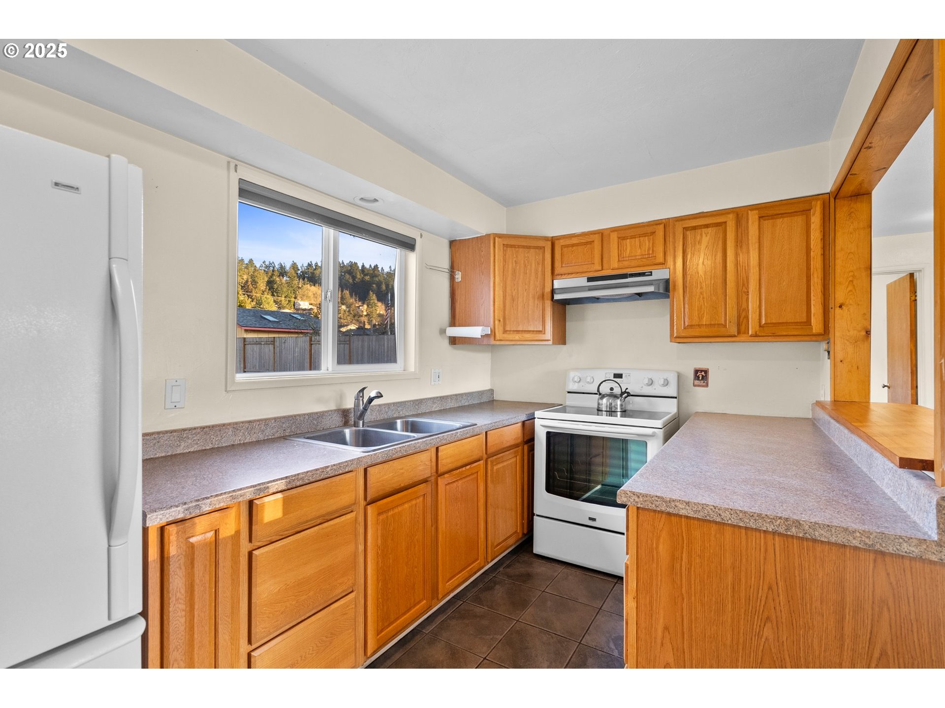 3875 East Amazon Drive Eugene, OR 97405 - Photo 16 of 33 a kitchen with stainless steel appliances granite countertop a sink stove and refrigerator