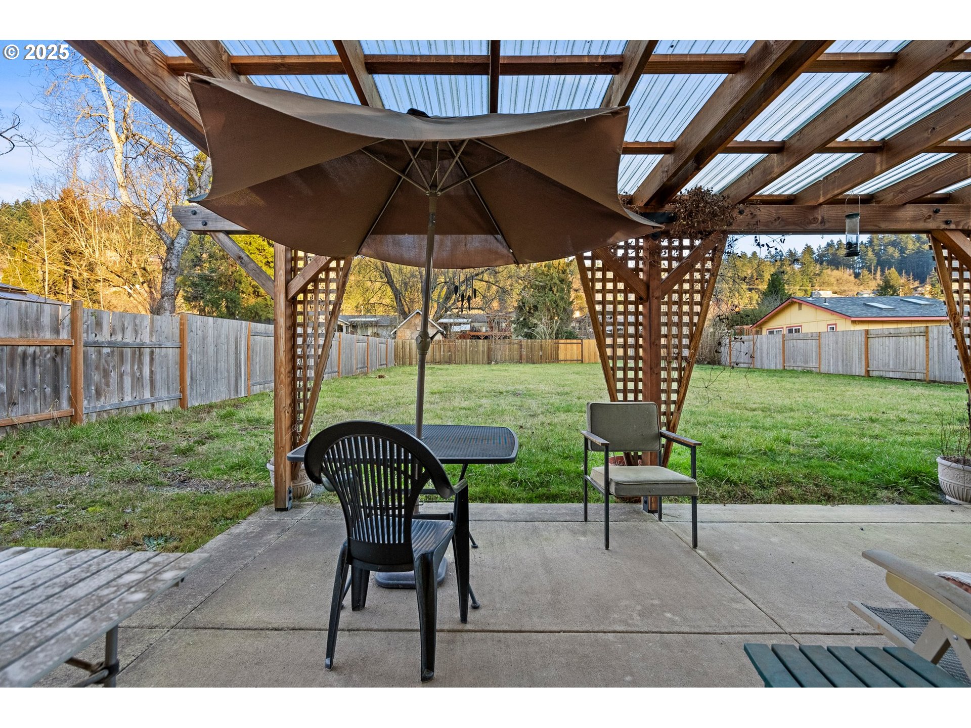 3875 East Amazon Drive Eugene, OR 97405 - Photo 26 of 33 a view of yard with table and chairs under an umbrella with a small yard