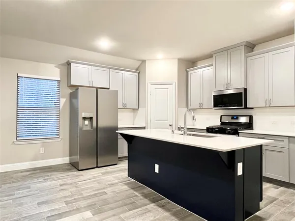 a view of a kitchen with a sink and a window