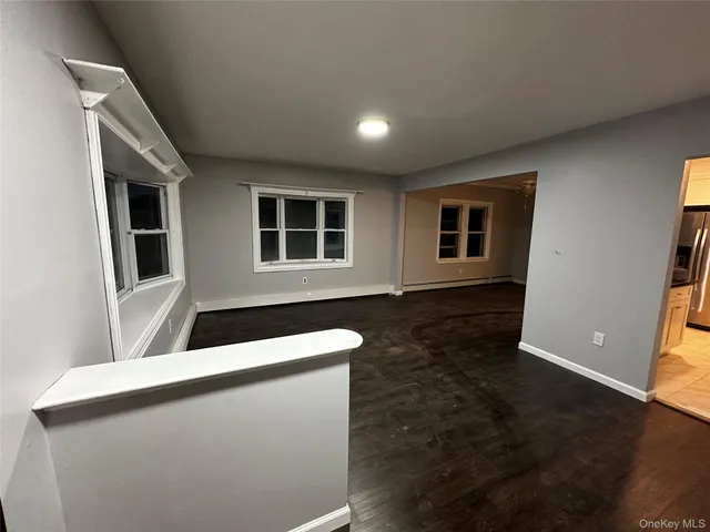 a kitchen with stainless steel appliances granite countertop a sink a stove a refrigerator a washer dryer and a refrigerator