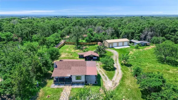 an aerial view of a house with garden space and street view