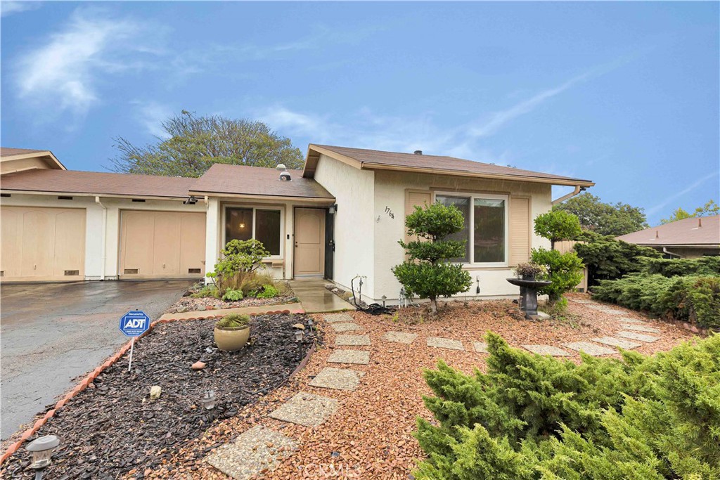 a front view of a house with yard patio and outdoor seating