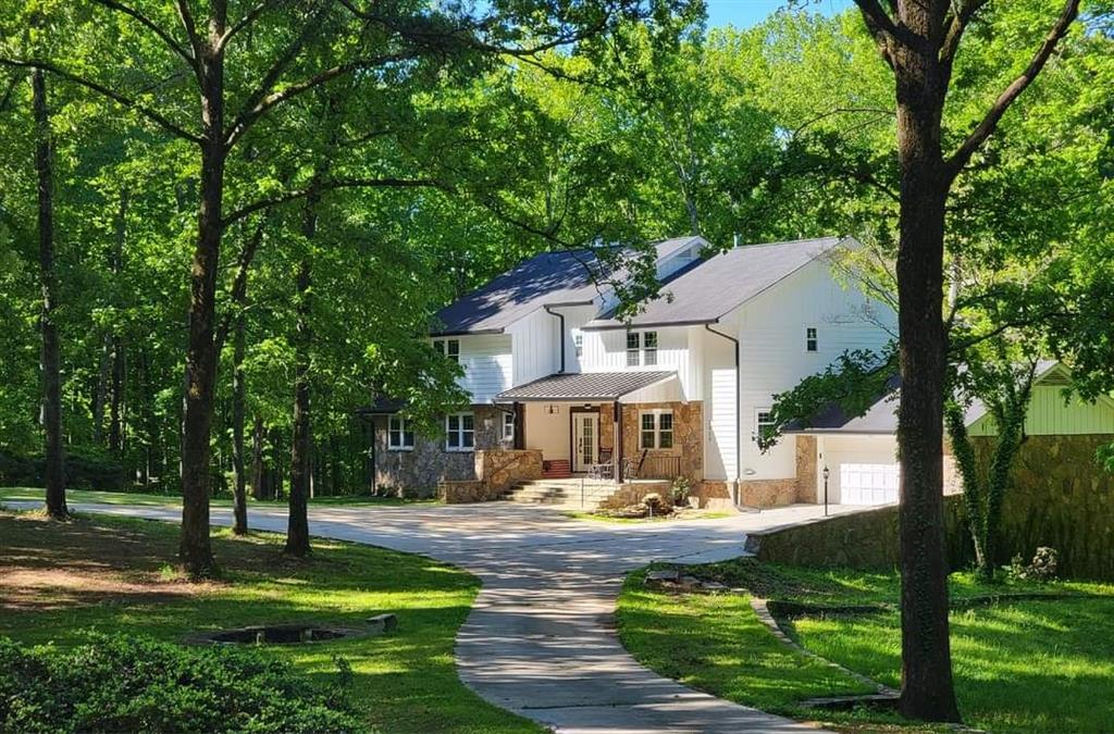 2900 Orchard Road Southwest Conyers, GA 30094 - Photo 1 of 63 a front view of a house with swimming pool and trees