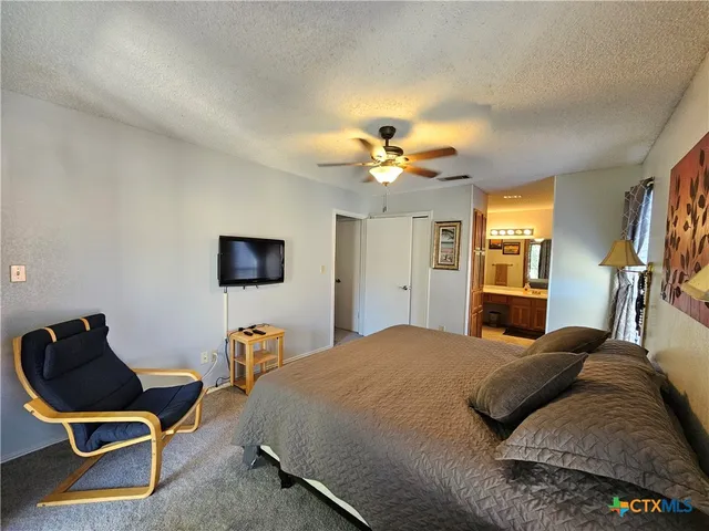 a bedroom with a bed and chair