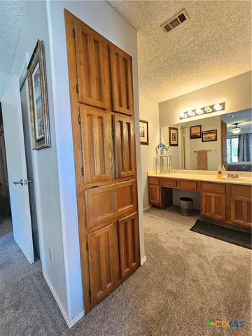 a spacious bathroom with a toilet sink and mirror