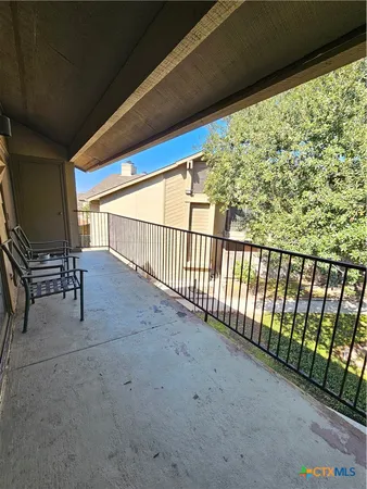 a view of balcony with furniture