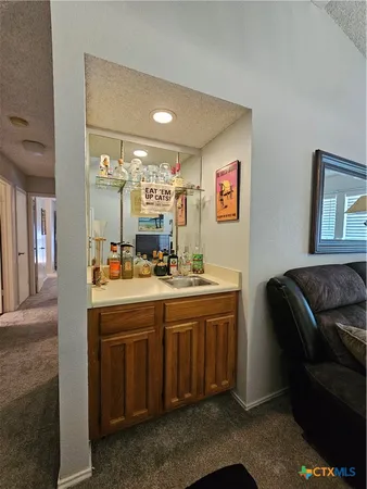 a kitchen with a sink cabinets and window