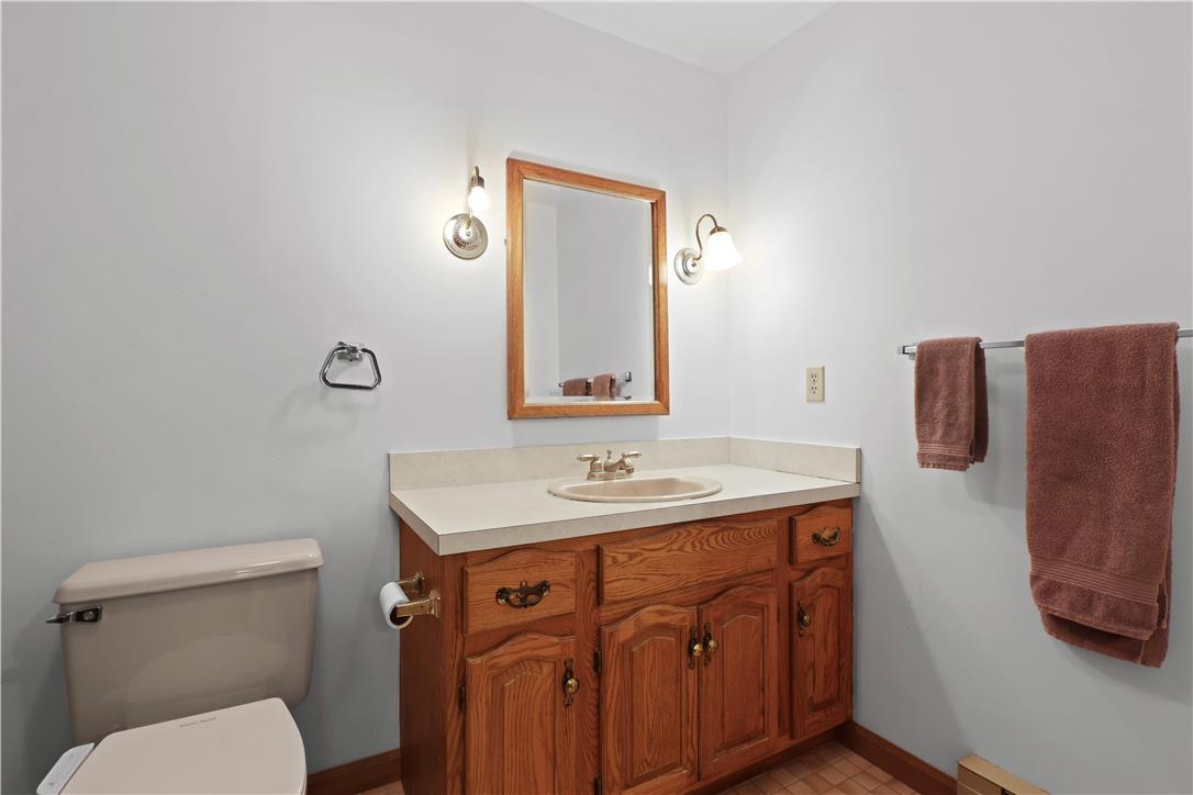 209 Remington Road East Stroudsburg, PA 18301 - Photo 30 of 41 A classic bathroom vanity with a framed mirror and dual wall sconces provides practicality and traditional style.