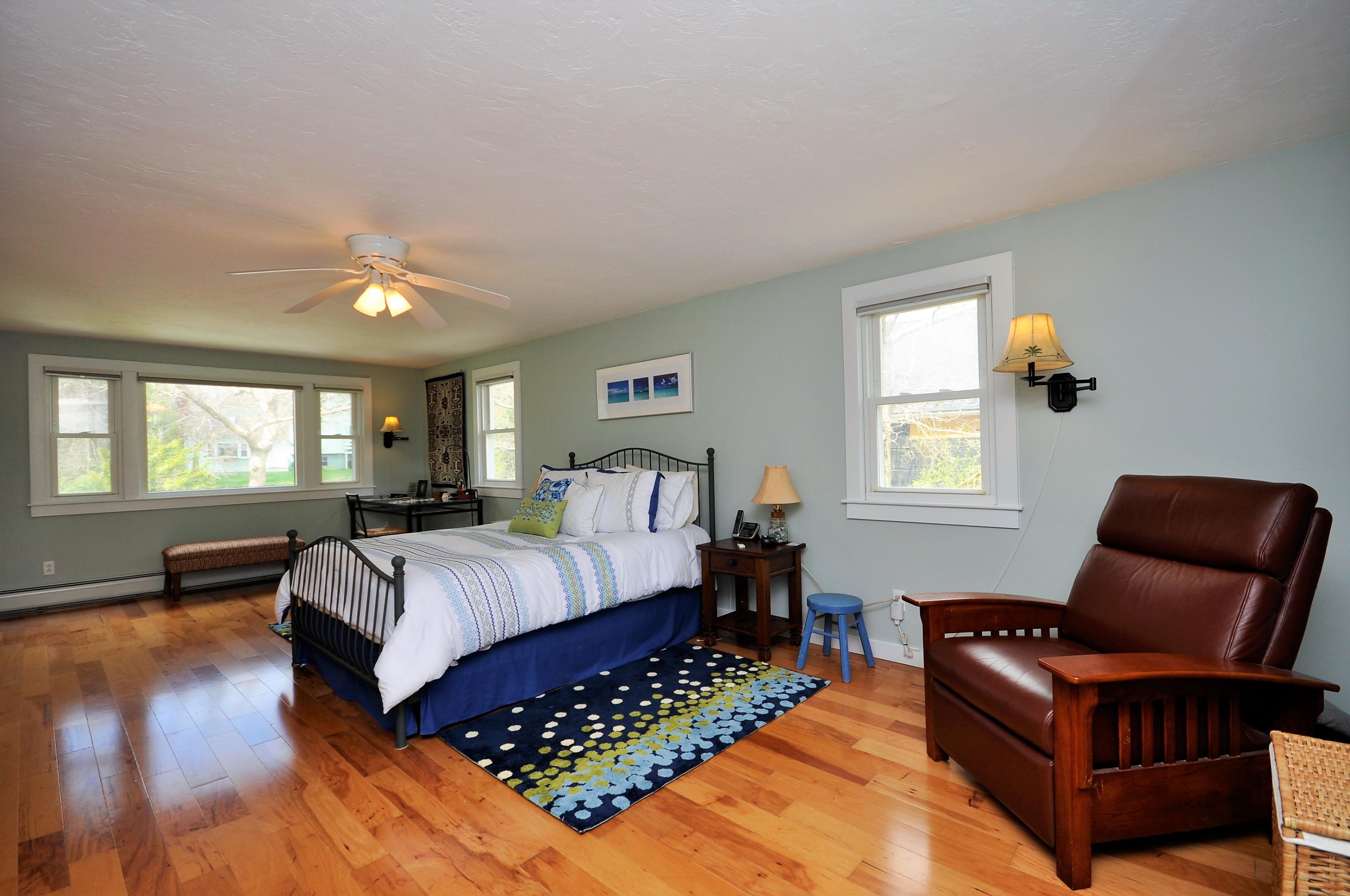 8 McGrath Road Sagamore Beach, MA 02562 - Photo 11 of 25 a bedroom with a bed wooden floor and window