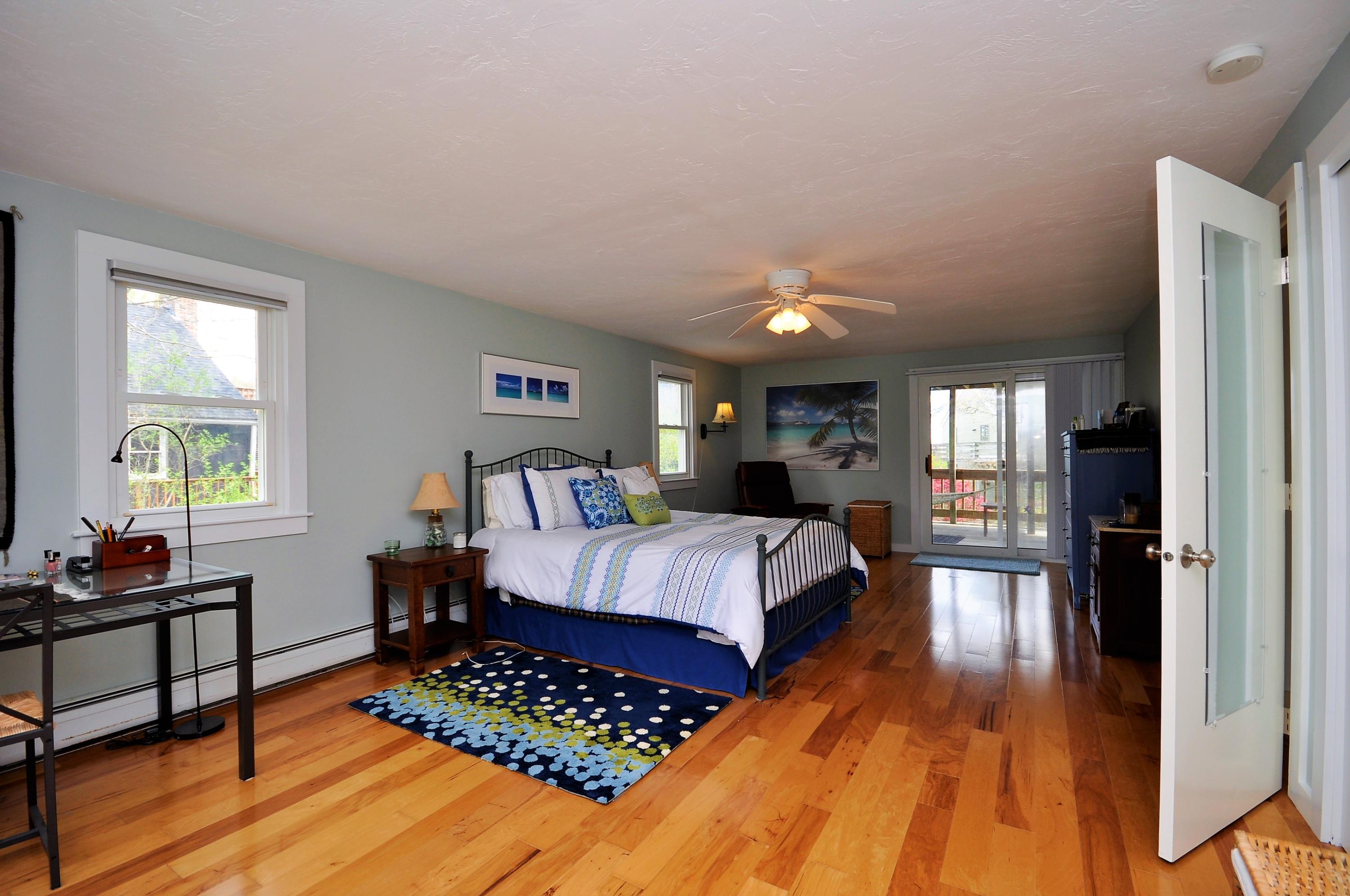 8 McGrath Road Sagamore Beach, MA 02562 - Photo 12 of 25 a bedroom with furniture and wooden floor