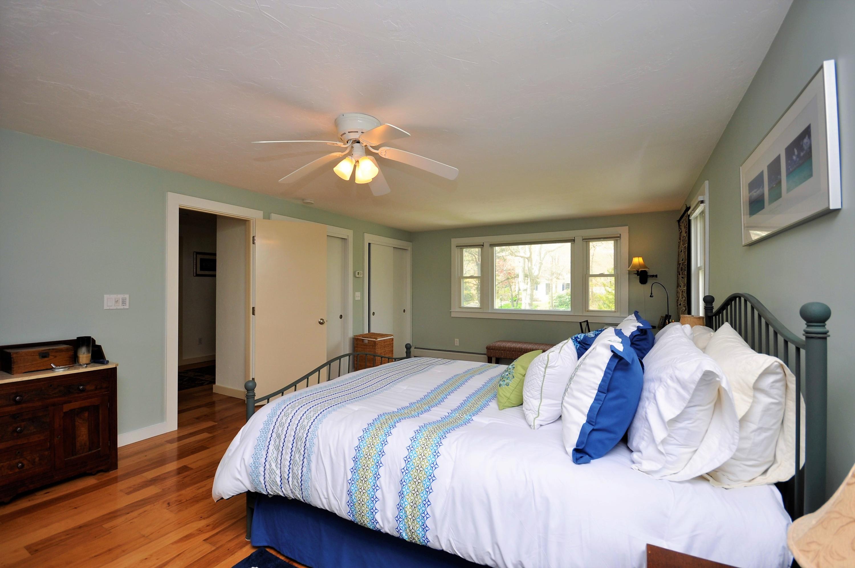 8 McGrath Road Sagamore Beach, MA 02562 - Photo 13 of 25 a bedroom with a bed and wooden floor