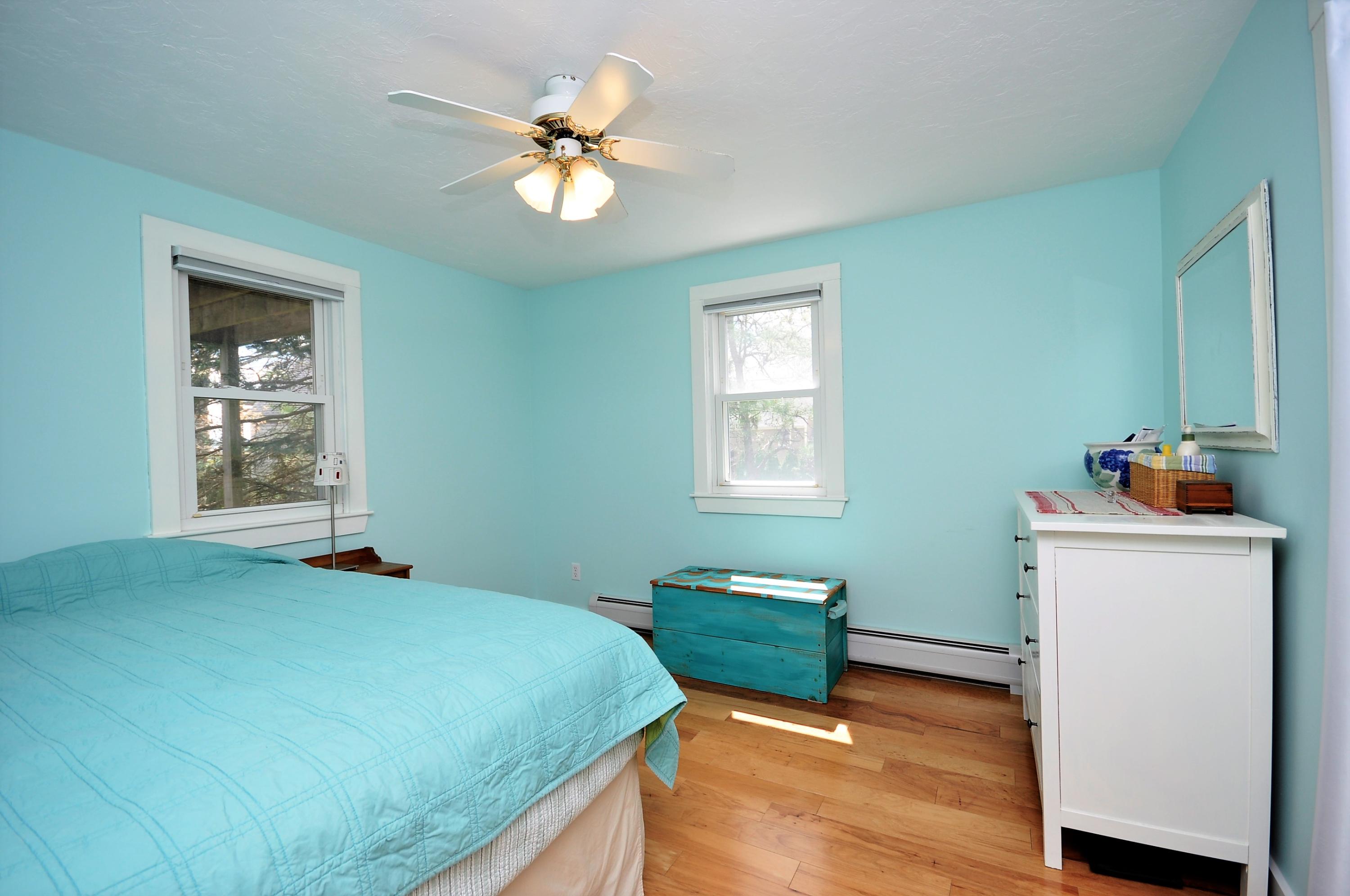 8 McGrath Road Sagamore Beach, MA 02562 - Photo 16 of 25 a bedroom with a bed and a chandelier