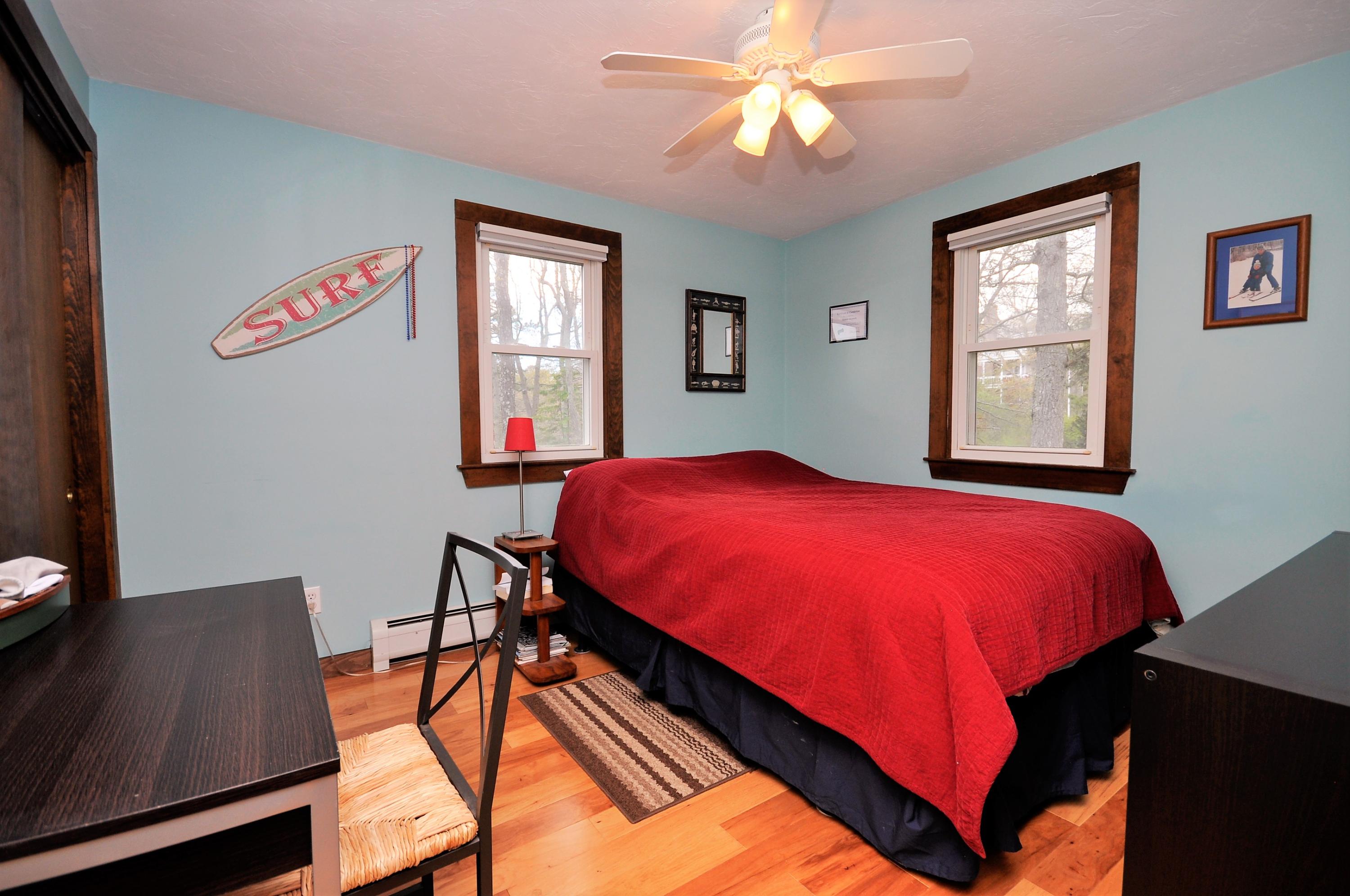 8 McGrath Road Sagamore Beach, MA 02562 - Photo 18 of 25 a bed sitting in a bedroom next to a window