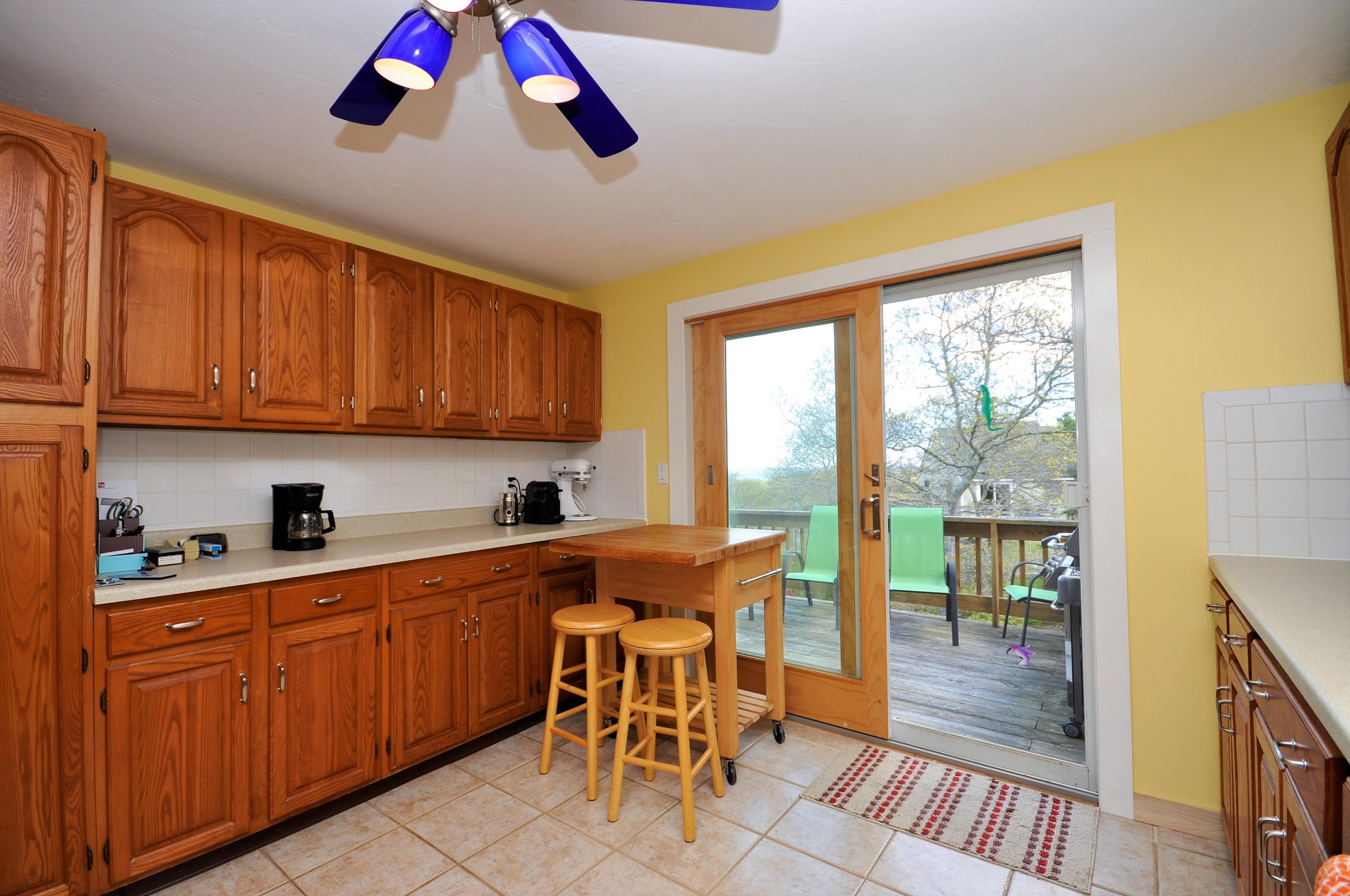 8 McGrath Road Sagamore Beach, MA 02562 - Photo 3 of 25 a view of a kitchen with wooden floor and furniture