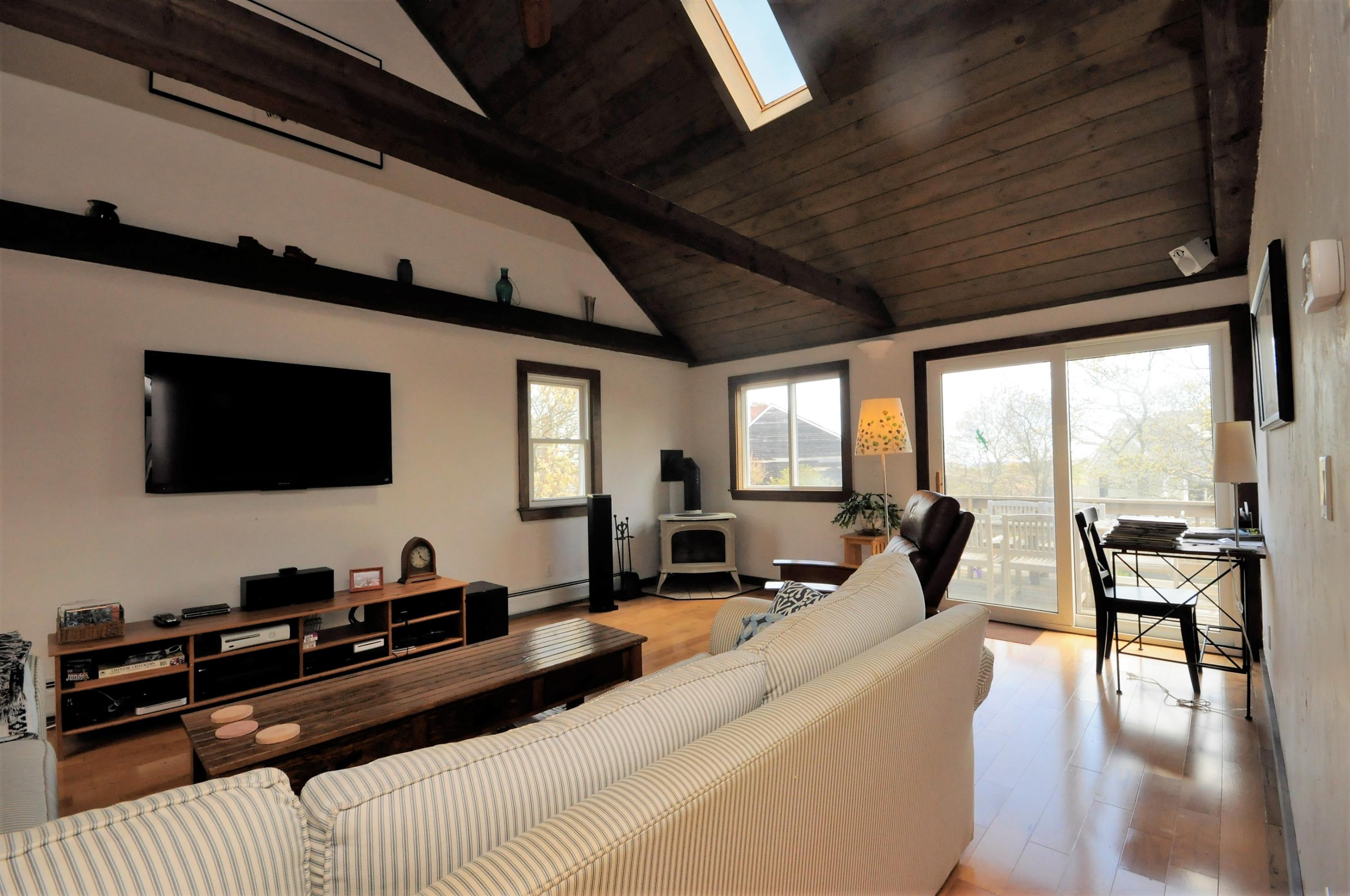 8 McGrath Road Sagamore Beach, MA 02562 - Photo 7 of 25 a living room with furniture and a flat screen tv