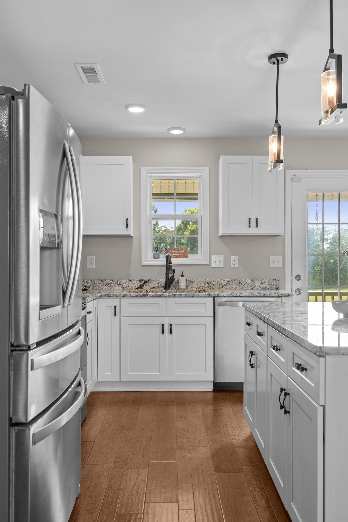 3232 Owl Hollow Road Belvidere, TN 37306 - Photo 8 of 43 a kitchen with granite countertop white cabinets and white appliances