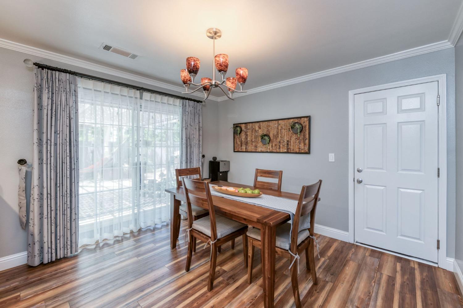 25106 Ave 18 Madera, CA 93638 - Photo 12 of 66 a view of a dining room with furniture window and wooden floor