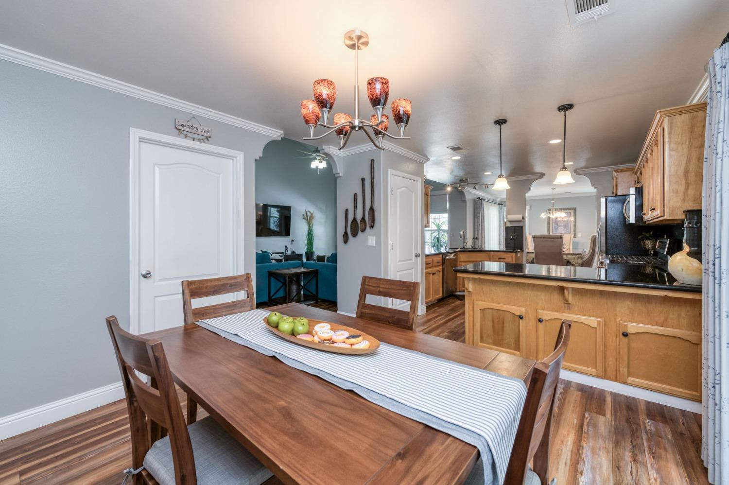 25106 Ave 18 Madera, CA 93638 - Photo 14 of 66 a view of a dining room with furniture and wooden floor