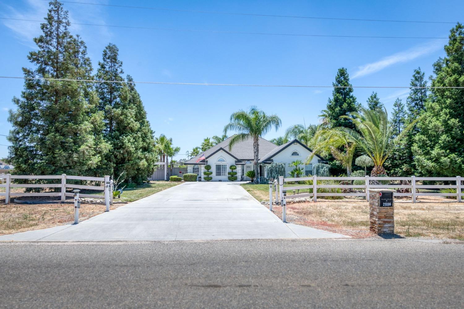 25106 Ave 18 Madera, CA 93638 - Photo 2 of 66 a house with trees in front of it