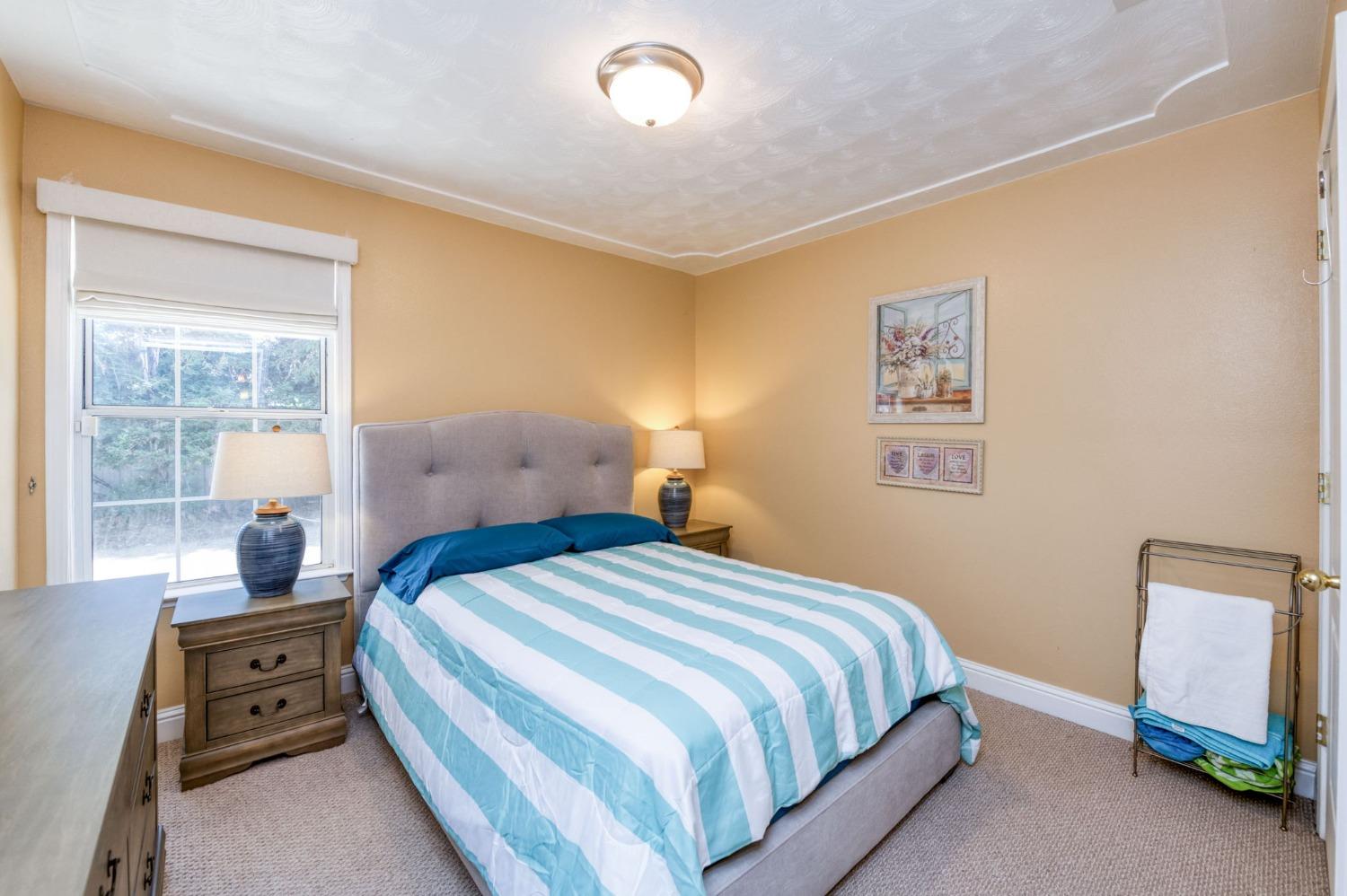 25106 Ave 18 Madera, CA 93638 - Photo 21 of 66 a bedroom with a bed and a window