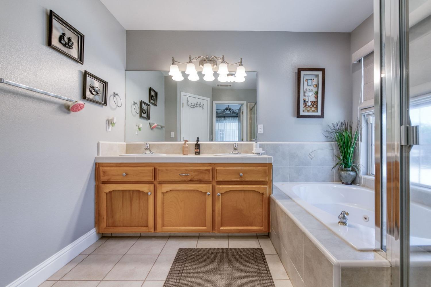 25106 Ave 18 Madera, CA 93638 - Photo 25 of 66 a bathroom with a tub sink and mirror