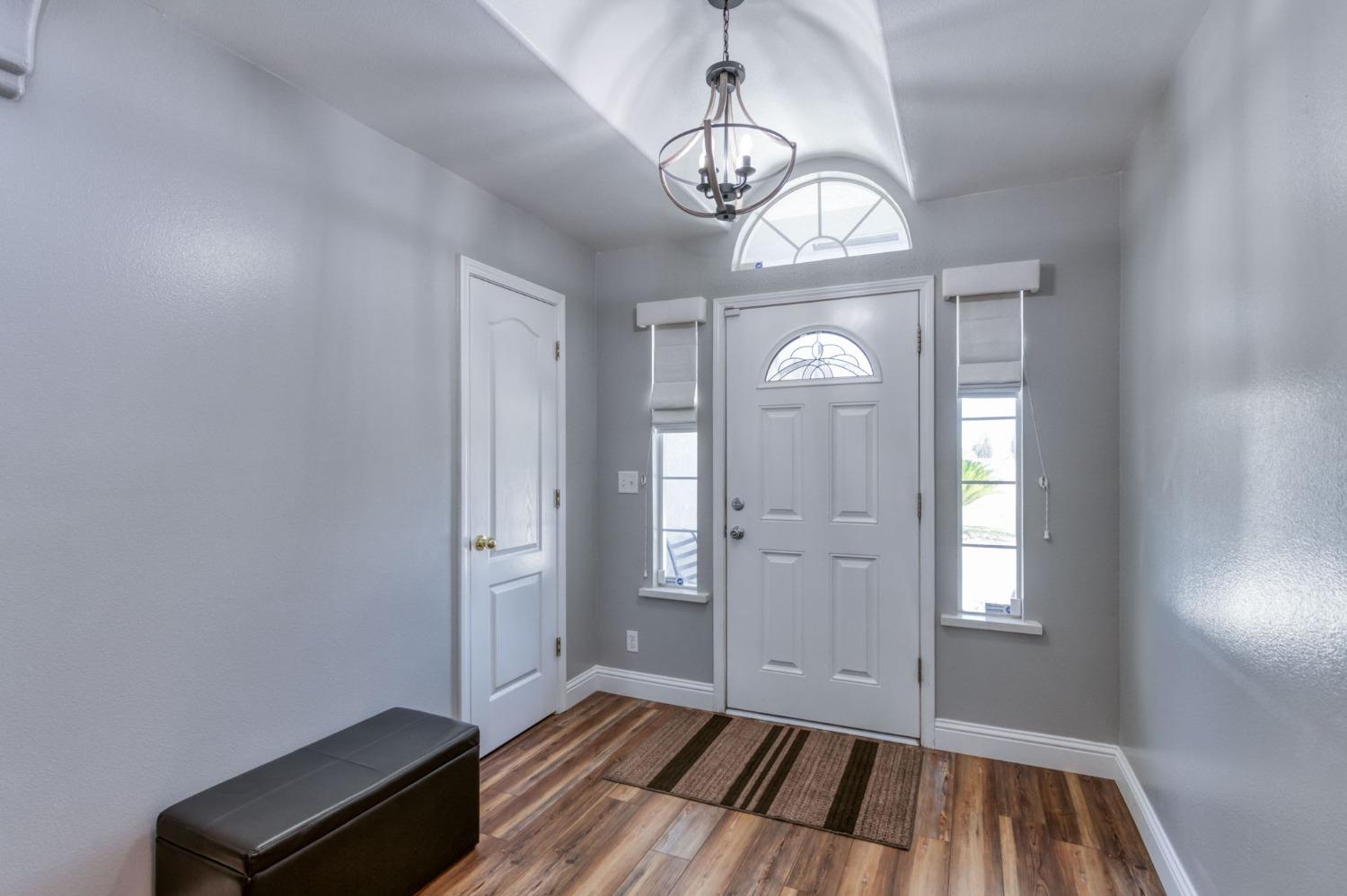25106 Ave 18 Madera, CA 93638 - Photo 3 of 66 a view of a livingroom with wooden floor and a window