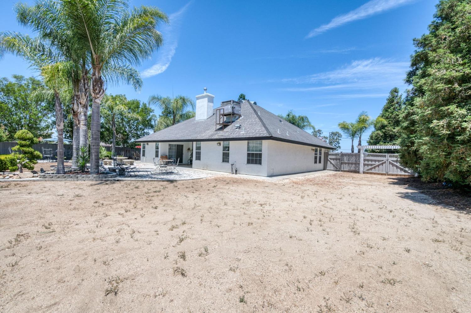 25106 Ave 18 Madera, CA 93638 - Photo 42 of 66 a front view of house with yard and trees