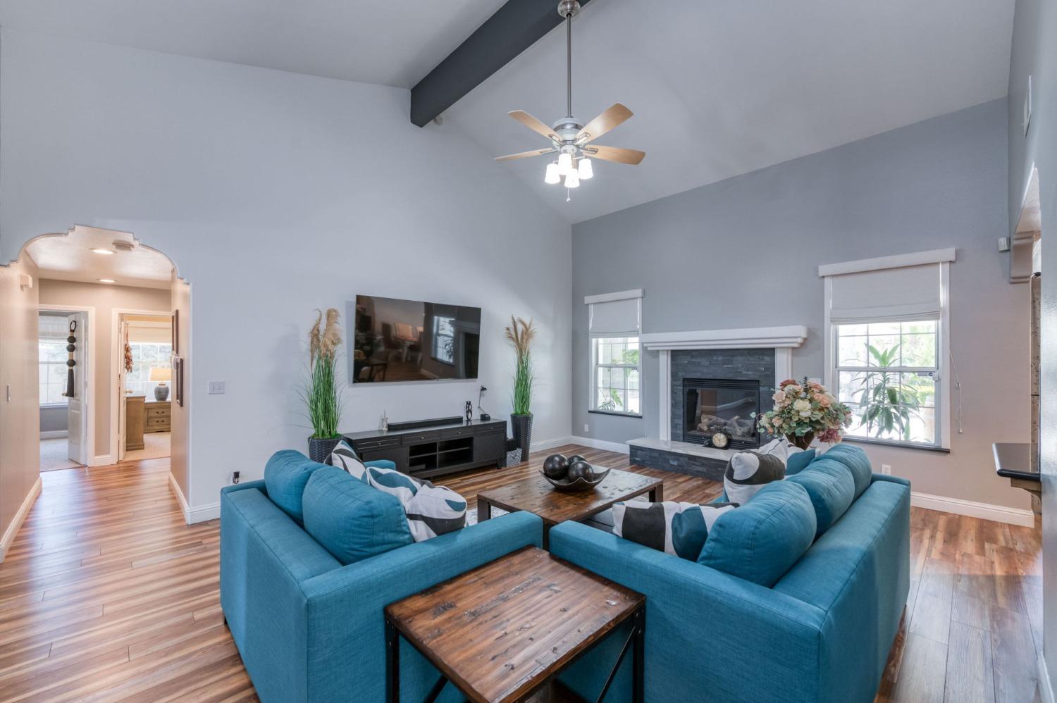 25106 Ave 18 Madera, CA 93638 - Photo 5 of 66 a living room with furniture and a fireplace