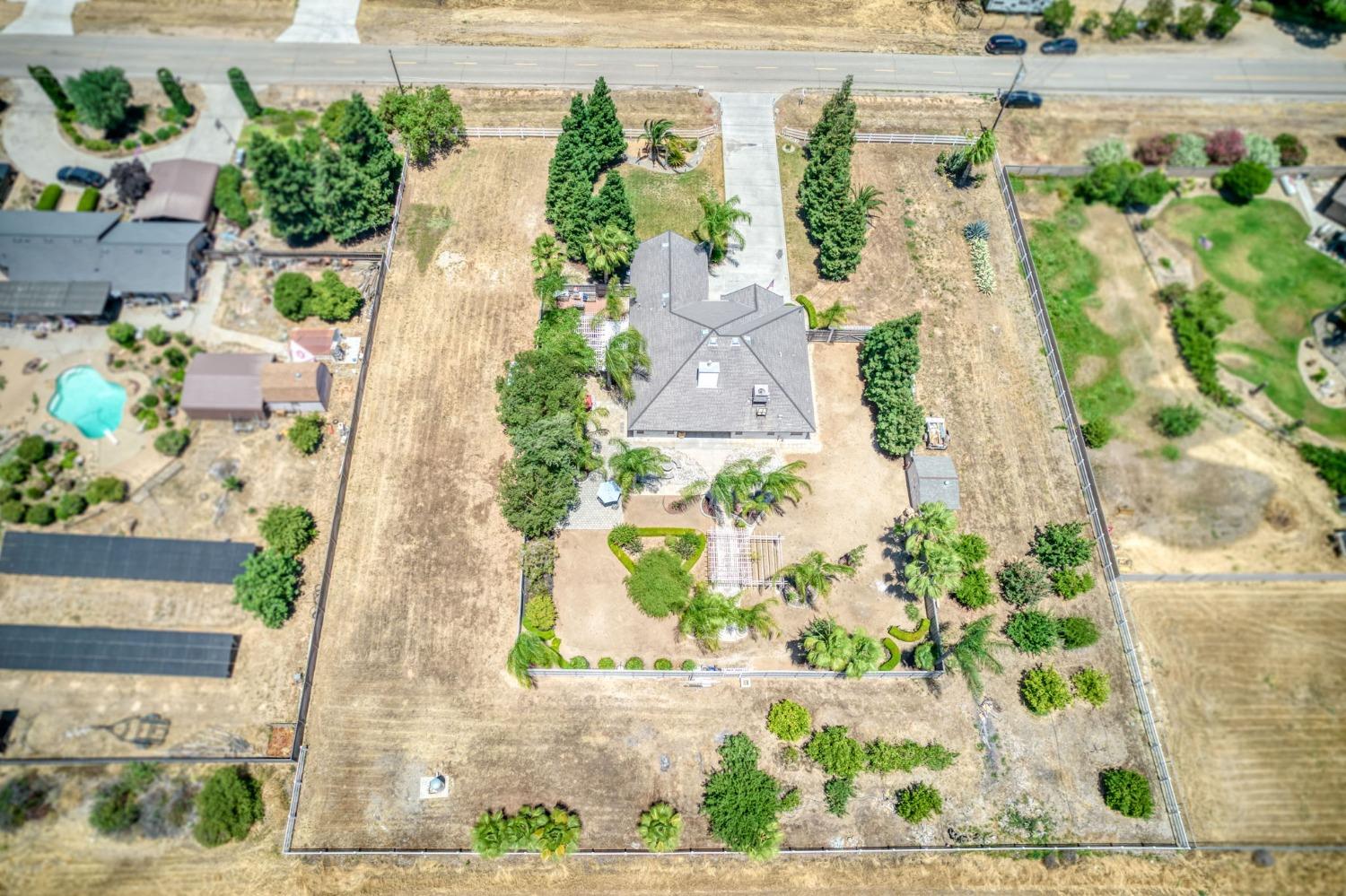 25106 Ave 18 Madera, CA 93638 - Photo 52 of 66 an aerial view of a house with a yard and a large parking space